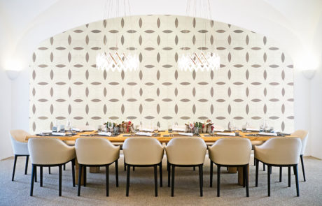 A Custom Interlocking Circle Elevation Panel made of Veneer on a Wall in a Dining Room